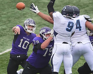 ALLIANCE, OHIO - DECEMBER 13, 2014: Kevin Burke #10 of Mount Union throws a pass behind the block of Alex Goff #79 on Aamir Petrose #9 and Payton Rose #94 of Wesley during the 1st half of Saturday afternoons game at Mount Union Stadium. Mount Union won 70-21. (photo by David Dermer/Youngstown Vindicator)