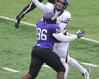 ALLIANCE, OHIO - DECEMBER 13, 2014:Joe Callahan #14 of Wesley is hit by Ted Rosalva #96 of Mount Union during the 1st half of Saturday afternoons game at Mount Union Stadium. Mount Union won 70-21. (photo by David Dermer/Youngstown Vindicator)