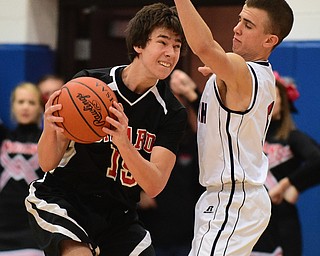 POLAND, OHIO - DECEMBER 13, 2014: Dylan O'Hara #15 of Girard attempts to go to the basket while being guarded by Jake Bullen #5 of Fitch during the 2nd half of Saturday afternoons game at Poland High School. (Photo by David Dermer/Youngstown Vindicator)