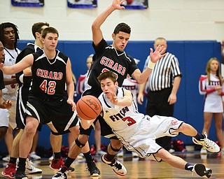 POLAND, OHIO - DECEMBER 13, 2014: Scott Duffy #3 of Fitch passes the ball while falling to the ground while being guarded by Tyler Kilbourne #42 and Chaston Williams #20 of Girard during the 2nd half of Saturday afternoons game at Poland High School. (Photo by David Dermer/Youngstown Vindicator)