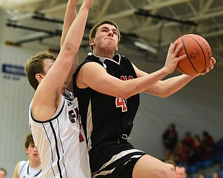 POLAND, OHIO - DECEMBER 13, 2014: Tyler Kilbourne #42 of Girard goes to the basket while being guarded by Anthony Pangio #11 of Fitch during the 2nd half of Saturday afternoons game at Poland High School. (Photo by David Dermer/Youngstown Vindicator)