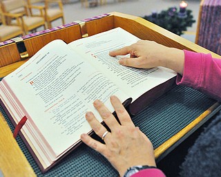 Jeff Lange | The Vindicator  Sister Lisa Marie Belz points to a passage that she will be covering during the Advent program, Thursday, Dec. 4th at the Ursuline Center in Canfield.