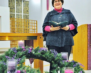 Jeff Lange | The Vindicator Sister Lisa Marie Belz stands with Bible in hands next to the Advent wreath, Thursday, Dec. 4th at the Ursuline Center in Canfield.