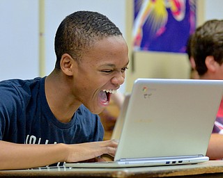 Jeff Lange | The Vindicator  Miles Spearman (14), eighth grader at Boardman Middle School, has a moment of joy as he tests his Flappy Bird program during the hour of Code at Boardman Middle School, Wednesday afternoon.