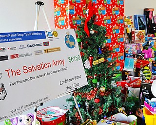 Jeff Lange | The Vindicator  At left is a check written out to the Salvation Army along with toys raised by UAW at the Lordstown GM Plant, Tuesday afternoon.