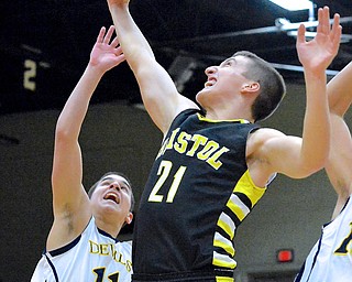 Jeff Lange | The Vindicator  Bristol's Alex Jones (21) brings down a rebound over McDonald's David Rebraca (11) in the first quarter of Saturday night's game at Struthers Field House.