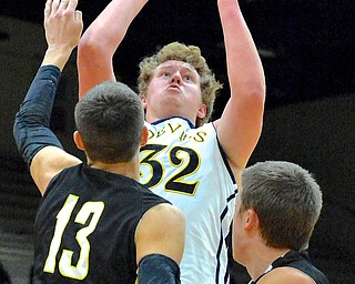 Jeff Lange | The Vindicator  Matthew Howard of McDonald (32) looks over Bristol's Aaron Williams (13) and Nathan Novicki (right) as he attempts a 2 in the first quarter of Saturday night's game in Struthers as part of the Hope Classic Showcase.