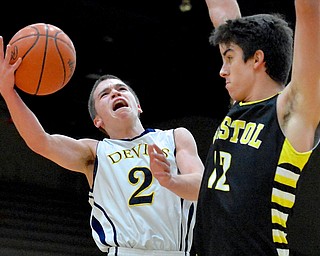 Jeff Lange | The Vindicator  McDonald's Anthony Pugh (2) looks to the basket as he attempts a layup past Bristol's Jaime de Lope (right) in the first period of Saturday night's matchup in Struthers as part of the Hope Classic Showcase.