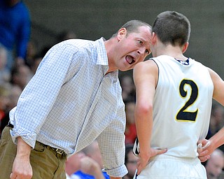 Jeff Lange | The Vindicator  McDonald head coach Jeff Rasile (left) talks some sense into Blue Devils' Anthony Pugh during late fourth period action in Struthers as part of the Hope Classic Showcase, Saturday evening.