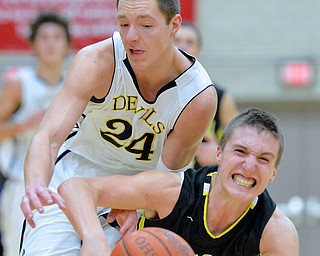 Jeff Lange | The Vindicator  Devils' Brad Woodley (24) and Bristol's Alex Jones take to the floor as they fight for possession of the ball during late second half action in Struthers.