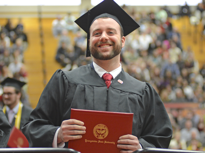 Katie Rickman | The Vindicator.David William Berry smiles at family members after receiving his  Bachelor of Engineering degree at commencement at Youngstown State University on Sunday, Dec. 14, 2014 at the Beeghly Center.