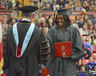 Katie Rickman | The Vindicator.Shalonda Shenell Farley is all smiles after receiving her Associate of Applied Science degree, she shakes the hand of Jim Tressel at Youngstown State University on Sunday, Dec. 14, 2014 at the Beeghly Center.