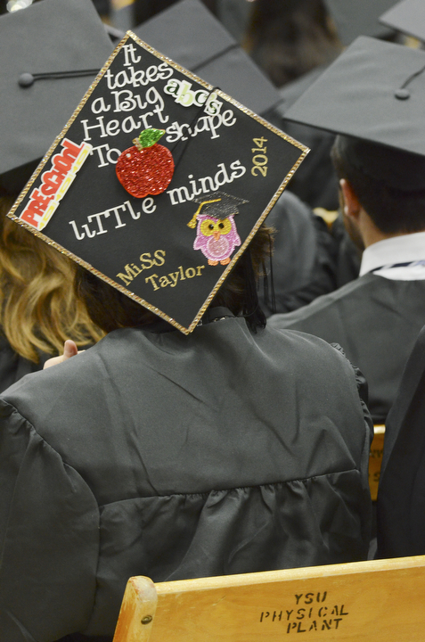 Katie Rickman | The Vindicator.Taylor Richards sports a decked out graduation cap during commencement at Youngstown State University on Sunday, Dec. 14, 2014 at the Beeghly Center.