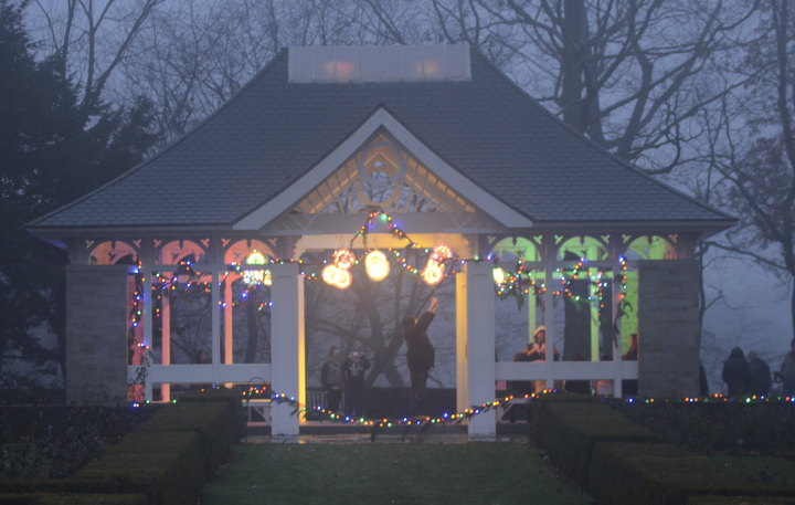 Katie Rickman | The Vindicator.Locals take pictures of the pavilion that is lit up with Christmas lights and decorations at Fellows Riverside Garden's Winter Nights display on Sunday, Dec. 14, 2014.