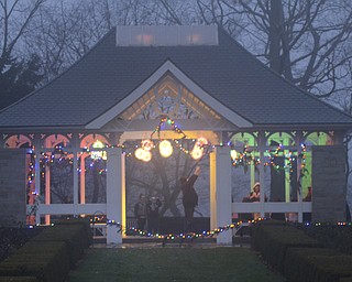 Katie Rickman | The Vindicator.Locals take pictures of the pavilion that is lit up with Christmas lights and decorations at Fellows Riverside Garden's Winter Nights display on Sunday, Dec. 14, 2014.