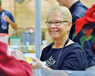 Jeff Lange | The Vindicator  Sandy Tullio of Poland serves the frequent volunteers in the district a breakfast consisting of eggs, bacon, potatoes, sausage and biscuits and gravy, Saturday morning during the appreciation breakfast at Canfield High School.
