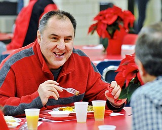Jeff Lange | The Vindicator  Joe Mikolay (facing) of Canfield shares a moment with friend Joe Bouch as he eats during Saturday's appreciation breakfast at Canfield High School for those who volunteer in the district.