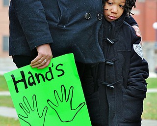 Jeff Lange | The Vindicator  Robert Baugh, age six and mother Shamatee White of Warren were among the few who braved the freezing temperatures to protest violence, Saturday afternoon in front of the Warren courthouse.