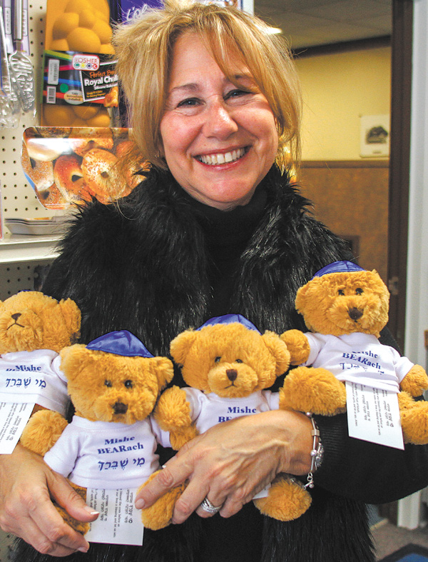 Darlene Muller, wife of Rabbi Franklin Muller of Congregation Rodef Sholom, holds a group of Mishe Bearach,
small teddy bears that are available at the synagogue’s gift shop. The bears, which come with a healing prayer, are among Judaic gift items available including ones for Hanukkah. The eight-day festival of lights begins at sundown tonight.