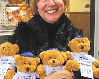 Darlene Muller, wife of Rabbi Franklin Muller of Congregation Rodef Sholom, holds a group of Mishe Bearach,
small teddy bears that are available at the synagogue’s gift shop. The bears, which come with a healing prayer, are among Judaic gift items available including ones for Hanukkah. The eight-day festival of lights begins at sundown tonight.
