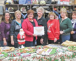 SPECIAL TO THE VINDICATOR: 
The Austintown Junior Women’s League recently helped serve cookies and cocoa to hundreds of children with Joyce Pogany and the Wickliffe Circle Christmas Committee at the Wickliffe Fire Station. The community Christmas tree was lit, and Santa arrived on a fire truck while the Austintown Fitch Brass Band performed Christmas carols. Those serving, from left, are Janet Polish, Kathy Mock, MaryAnn Herschel, Mary Toporcer, Kathy Rusback, Pogany, Shirley Schmidt, Janice Simmerman, Sue Hovanec, Deanna Hosey and Ruty Rodriguez Patterson.