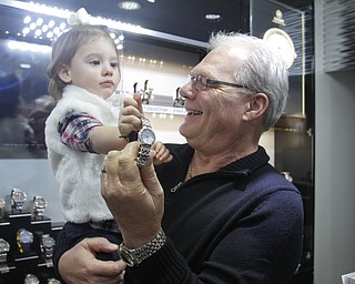        ROBERT K. YOSAY  | THE VINDICATOR..Mark   Cichanski  holds the fourth generation of Jewelers   Olivia 1 1/2  latest addition -  and most popular his Citizen band of Watches..(ladies diamond citizen)..Cirelli Jewelers.. Boardman