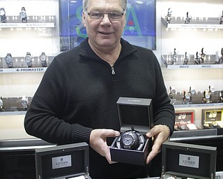        ROBERT K. YOSAY  | THE VINDICATOR..Mark   Cichanski  holds the latest addition -  and most popular his Citizen band of Watches....Cirelli Jewelers.. Boardman
