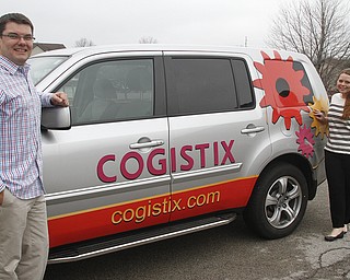        ROBERT K. YOSAY  | THE VINDICATOR..Kevin Miller and Staci Lombardo- with their service vehicle... Cogistix is a local software company created by Kevin Miller. The company employs more than 30 people and recently bought the former Hill, Barth & King Boardman location to move into in February.
