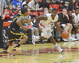 Katie Rickman | The Vindicator.YSU's DJ Cole (11) runs up court  as Kennesaw's Yonel Brown (4) guards him during the first half the game at Youngstown State University on Dec. 17, 2014.