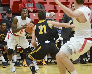 Katie Rickman | The Vindicator.YSU's Shaun Stewart (0) looks for an open pass as Kennesaw's Nick Masterson (21) blocks him during the first half the game at Youngstown State University on Dec. 17, 2014. YSU's Bobby Hain (20) waits for the pass.