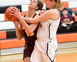 NEW MIDDLETOWN, OHIO - DECEMBER 15, 2014: Madison Durkin #13 of South Range is fouled while going to the basket by Kasey Kohler #41 of Springfield during the 1st half of Monday nights game at Springfield High School. (Photo by David Dermer/Youngstown Vindicator)