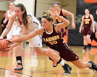 NEW MIDDLETOWN, OHIO - DECEMBER 15, 2014: Ashley Sharp #10 of South Range dives to attempt to rip the ball out of the hands of Callie Ford #11 of Springfield during the 1st half of Monday nights game at Springfield High School. (Photo by David Dermer/Youngstown Vindicator)