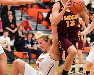 NEW MIDDLETOWN, OHIO - DECEMBER 15, 2014: Madison Durkin #13 of South Range secures the rebound away from a falling Kasey Kohler #41 of Springfield during the 1st half of Monday nights game at Springfield High School. (Photo by David Dermer/Youngstown Vindicator)