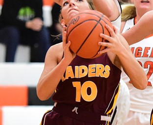 NEW MIDDLETOWN, OHIO - DECEMBER 15, 2014: Ashley Sharp #10 of South Range dips under the arm of Kasey Kohler #41 of Springfield during the 1st half of Monday nights game at Springfield High School. (Photo by David Dermer/Youngstown Vindicator)