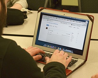 Katie Rickman | The Vindicator.Nick Serra founder of Code Youngstown works on fine-tuing an app for YNDC during a Code Youngstown meeting at YBI in Youngstown on Tuesday, Dec. 16, 2014.