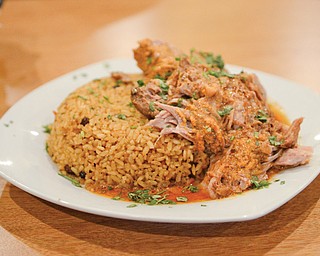 Pernil y arroz con gandules features roasted pork, Puerto Rican rice and pigeon peas.