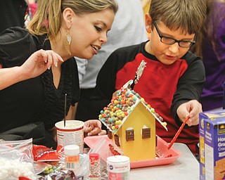 Kristine Botak and her nephew, Alec Dankovich, used different kinds of candy to trim their gingerbread house.