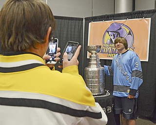 Katie Rickman | The Vindicator.Steven Flower, 15 of Sharon PA takes a photo of Zachary Hunchuk, 15 also of Sharon as he poses next to the Stanley Cup before the Phantoms game on Friday, Dec. 19, 2014.