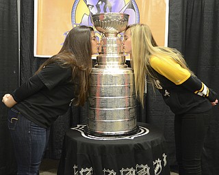 Katie Rickman | The Vindicator.Maria Joseph, 18 of Boardman, on left) and Alexis Downie, 18 also Boardman kiss the Stanley Cup before the Phantoms game on Dec. 19, 2014.