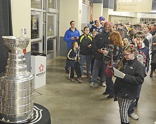 Katie Rickman | The Vindicator.Fans line up to take a photo with the Stanley Cup on Friday, Dec. 19, 2014 at the Covelli Centre.