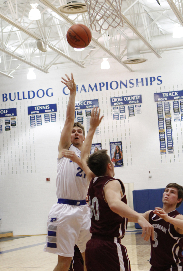 Poland's Kyle Dixon (21) goes up for a jump shot while being defended by Boardman's Holden Lipke (10) during the first half of Friday nights matchup at Poland Seminary High School. Dustin Livesay  |  The Vindicator  12/19/14  Poland Seminary High School.