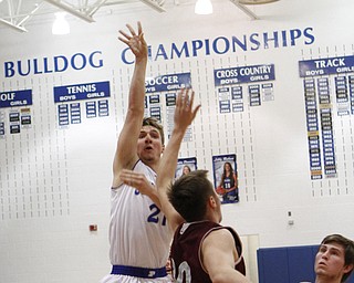 Poland's Kyle Dixon (21) goes up for a jump shot while being defended by Boardman's Holden Lipke (10) during the first half of Friday nights matchup at Poland Seminary High School. Dustin Livesay  |  The Vindicator  12/19/14  Poland Seminary High School.