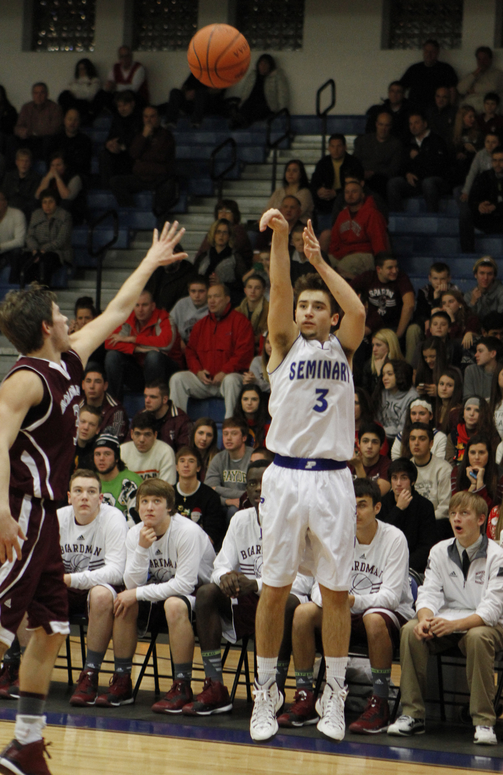 Poland's Nick Gajdos (3)attempts a 3-pointer while being defended by Boardman's Brian Fryda (3)  during the first half of Friday nights matchup at Poland Seminary High School. Dustin Livesay  |  The Vindicator  12/19/14  Poland Seminary High School.