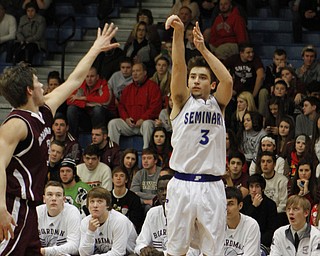 Poland's Nick Gajdos (3)attempts a 3-pointer while being defended by Boardman's Brian Fryda (3)  during the first half of Friday nights matchup at Poland Seminary High School. Dustin Livesay  |  The Vindicator  12/19/14  Poland Seminary High School.