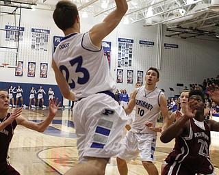 Poland's Jared Buckert (23) leaps to save the ball from going out of bounds and passes to teammate Tate Duarte (10) during the first half of Friday nights matchup at Poland Seminary High School. Dustin Livesay  |  The Vindicator  12/19/14  Poland Seminary High School.