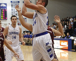 Poland's Austin Wilson (24) gets fouled while going up for a layup by Boardman's Jon Michael Dana (42) during the first half of Friday nights matchup at Poland Seminary High School. Dustin Livesay  |  The Vindicator  12/19/14  Poland Seminary High School.