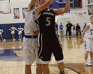 Boardman's Alex Duda (5) goes up for a layup while being fouled by Poland's Tate Duarte (10) during the second half of Friday nights matchup at Poland Seminary High School. Dustin Livesay  |  The Vindicator  12/19/14  Poland Seminary High School.