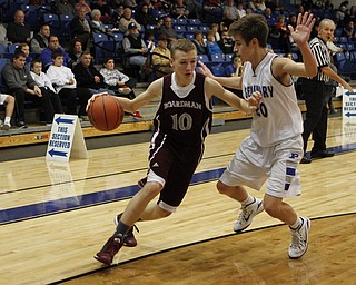 Boardman's Holden Lipke (10) tries to drive to the hoop while being defended by Poland's Mike Gajdos (20) during the second half of Friday nights matchup at Poland Seminary High School. Dustin Livesay  |  The Vindicator  12/19/14  Poland Seminary High School.