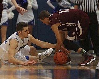 Poland's Tate Duarte (10) falls to the ground while he rips the ball away from Boardman's Gannon Murray (11) during the first half of Friday nights matchup at Poland Seminary High School. Dustin Livesay  |  The Vindicator  12/19/14  Poland Seminary High School.