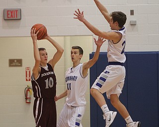 Boardman's Holden Lipke (10) tries to pass the ball but is closely defended by Poland's Matt Baker (11) and Mike Gajdos (20) during the first half of Friday nights matchup at Poland Seminary High School. Dustin Livesay  |  The Vindicator  12/19/14  Poland Seminary High School.